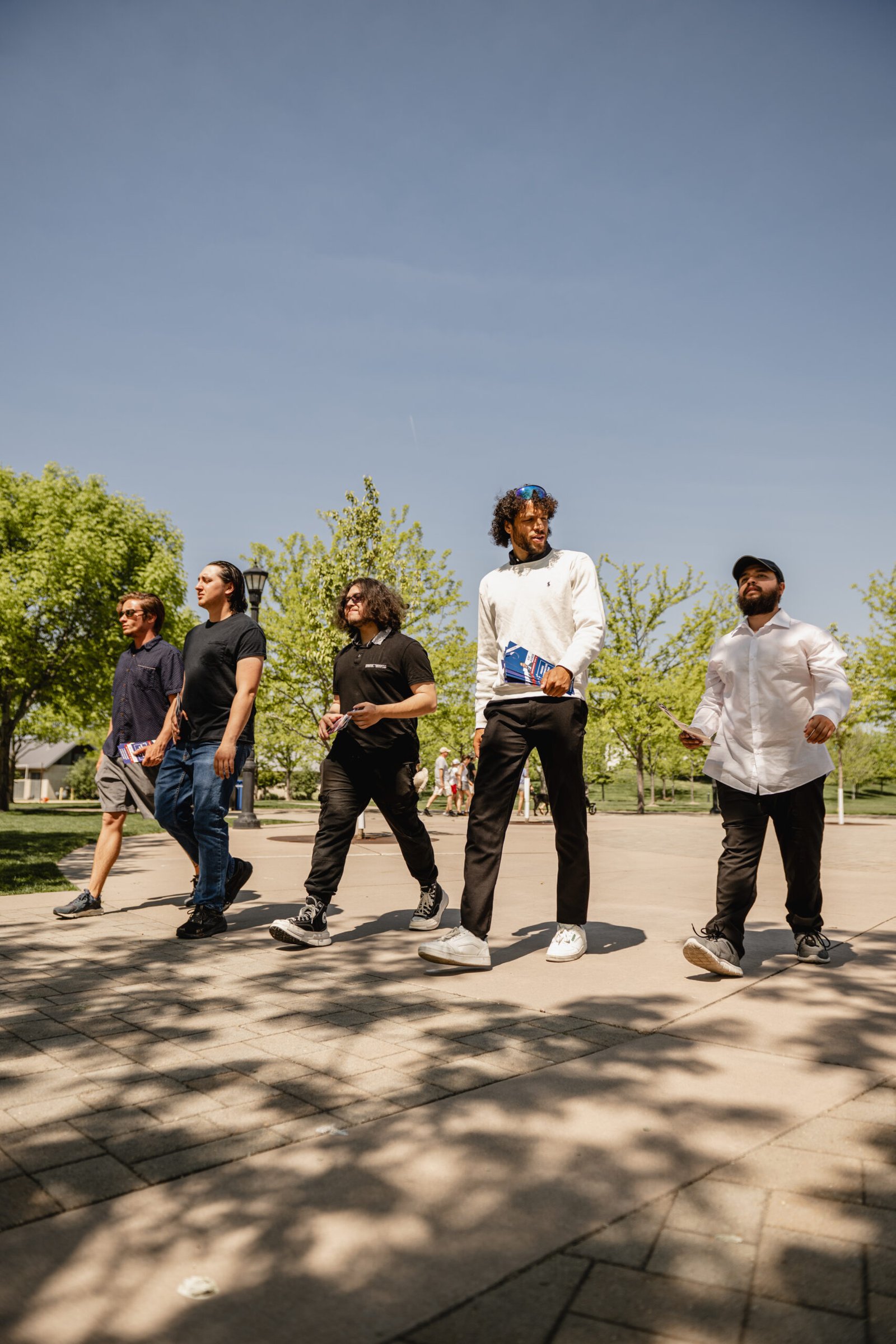 Group of individuals walking together outdoors, symbolizing unity and collective action. The image represents the collaborative effort to get involved with the Make Liberty Win Super PAC.